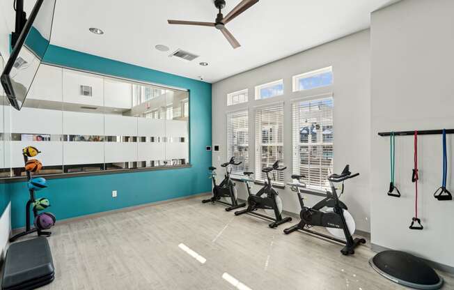 the gym with treadmills and weights at the belgard apartments