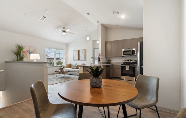 a kitchen and dining room with a table and chairs