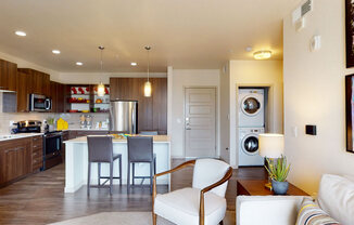 a kitchen and living room with a washer and dryer