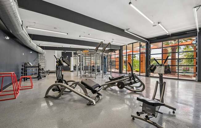 A gym with a variety of equipment including a leg press machine.