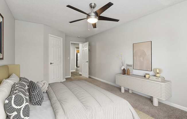 Model Bedroom with Carpet and Hallway View at Retreat at Stonecrest Apartments located in Lithonia, GA.