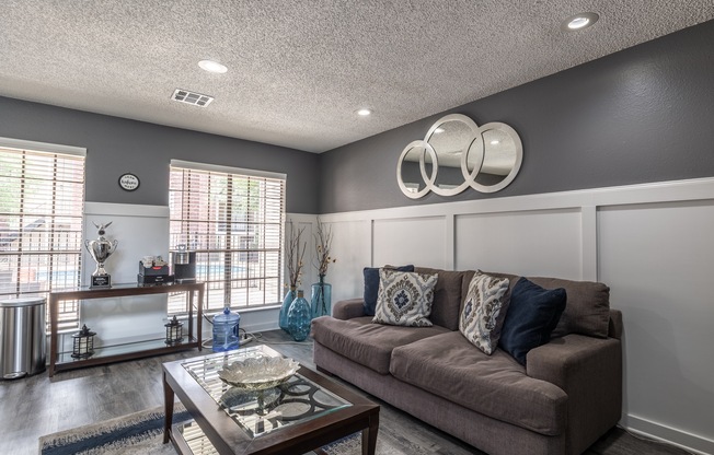 A living room with a brown couch and a coffee table.