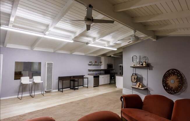 a living room with a ceiling fan and a kitchen