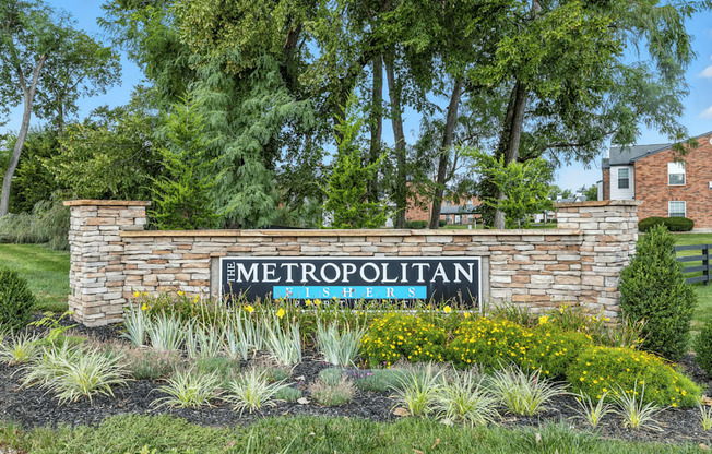 A sign that says Metropolitan in front of a building.