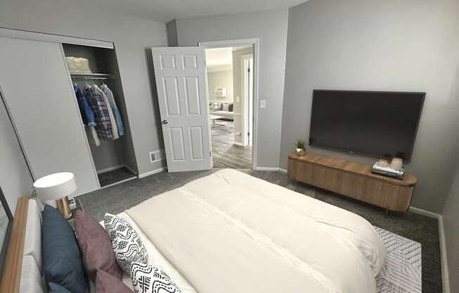 A bedroom with a large bed, a television, and a wardrobe.