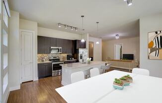 a kitchen and dining room with a white table