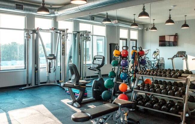 a gym with a lot of weights and a large window at Barrington 101, Barrington Illinois