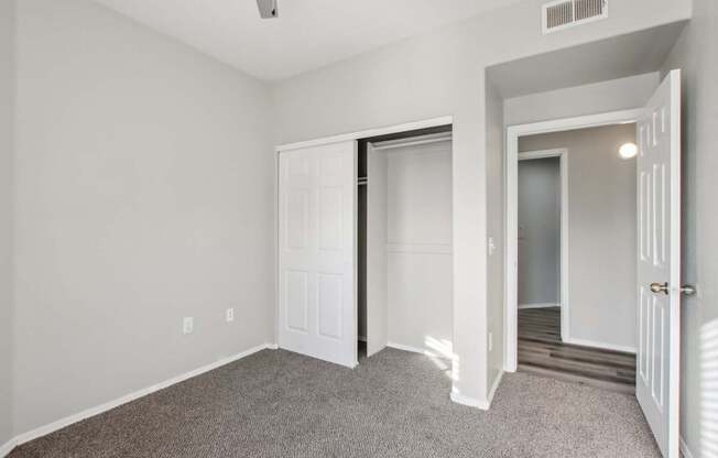 A room with a carpeted floor and white walls.