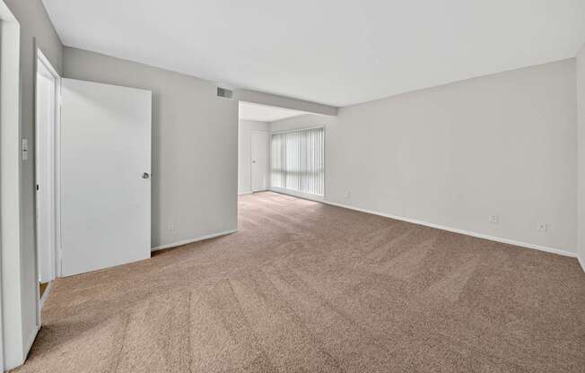 A room with carpeted floor and white walls.