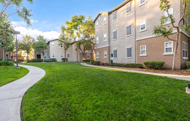 A grassy area in front of apartment buildings.