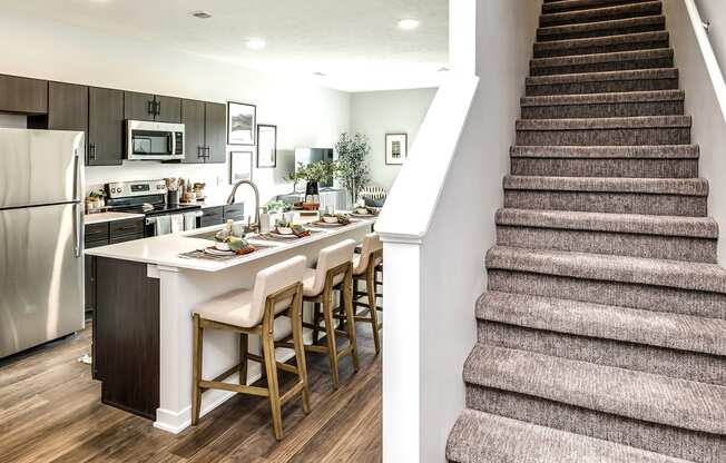Studio, one two and three bedroom apartments and townhomes featuring open concept floor plans, dens, large windows, stainless steel appliances, quartz countertops, eat-in kitchens, pantries, LVT flooring and much more at The Trails at North Streams in Omaha, NE