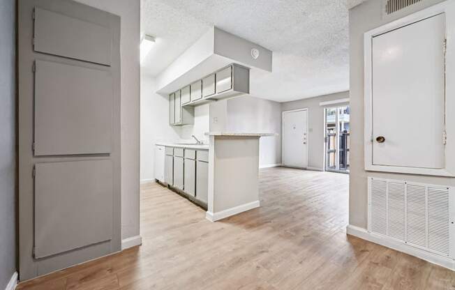 A room with a white door and a white cabinet.