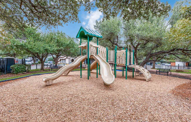 A playground with a green roof and a slide.