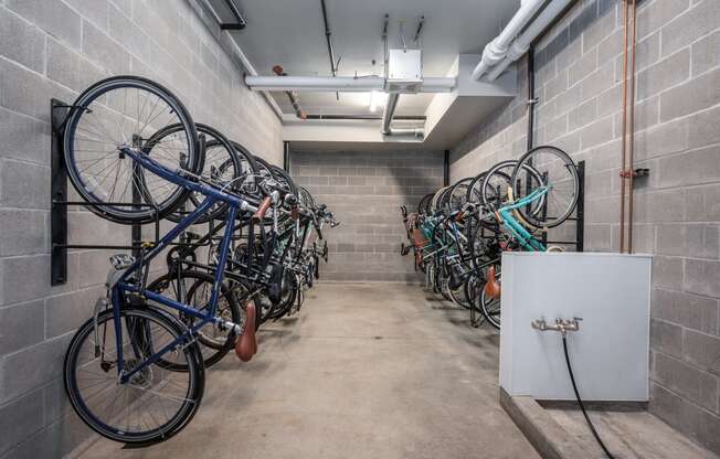 a row of bikes hanging on a wall in a room