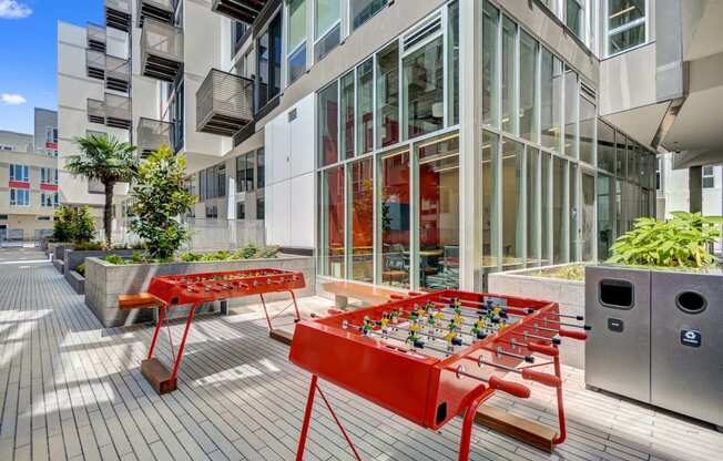 a foosball table on a patio in front of a building at L Seven, California, 94103