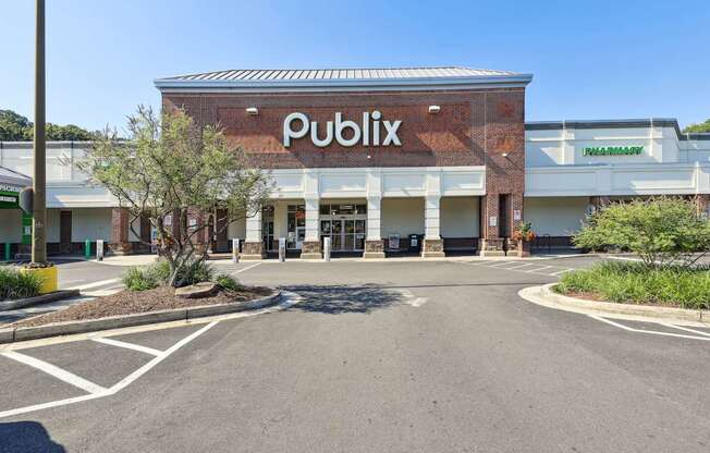 The image shows a Publix store with a clear blue sky in the background.