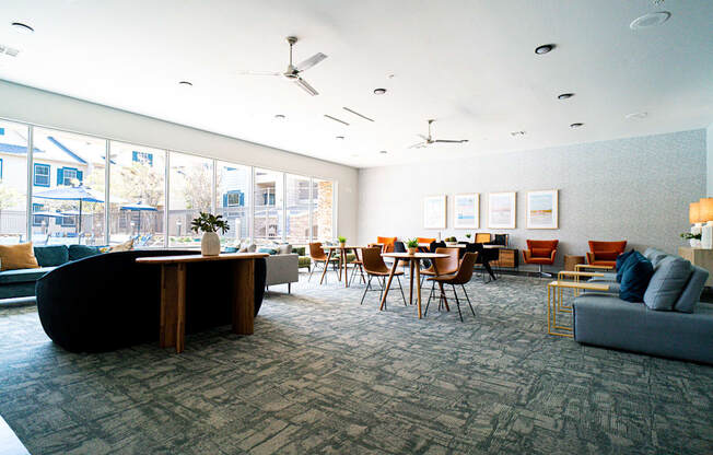 a large room with couches and chairs and a table with chairs