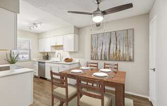 an open kitchen and dining room with a table and chairs at Acacia Gardens, Albuquerque, NM