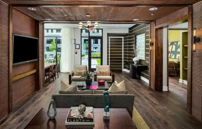 A living room with a wooden floor and a coffee table with a book on it.