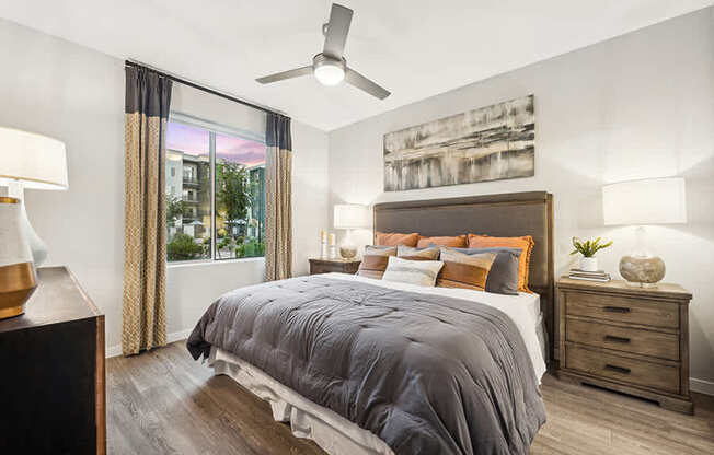 Model Bedroom with Wood-Style Flooring and Window View at Glen 91 Apartments located in Glendale, AZ.