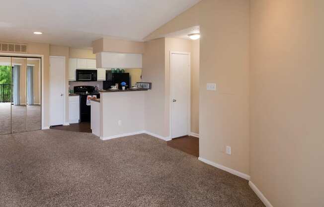 Living room and kitchen with a carpeted floor at The Glen at Highpoint, Dallas, TX, 75243