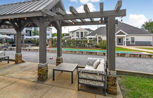 a patio with a couch and a table under a gazebo at Avalon Apartment Homes, Starkville, Mississippi