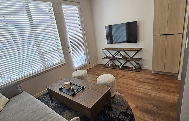 a living area with large windows at Lotus Republic Apartments for rent in Downtown Salt Lake City, Utah