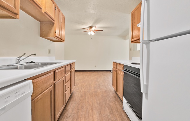 A kitchen with wooden cabinets and white appliances.