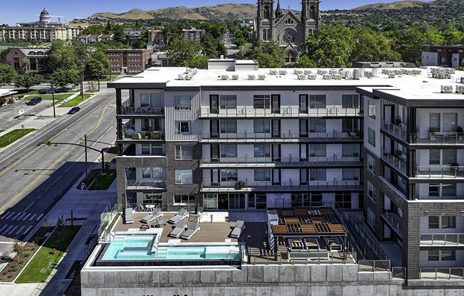 a drone shot of a pool and building at Lotus Republic Apartments for rent in Downtown Salt Lake City, Utah