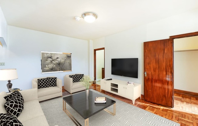 living area with sofa, coffee table, hardwood floors and view of bedroom at eddystone apartments in washington dc