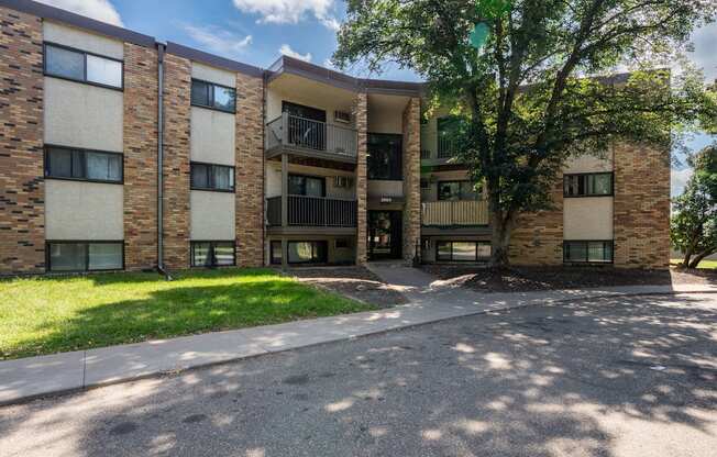 A large apartment complex with a tree in front. White Bear Lake, MN White Bear Terrace Apartments