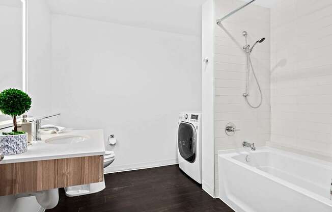 A white bathroom with a sink, toilet, and bathtub.