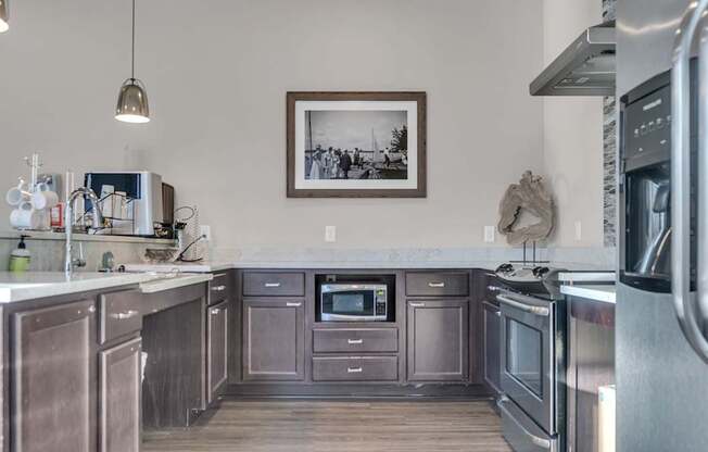 A kitchen with stainless steel appliances and wooden cabinets.