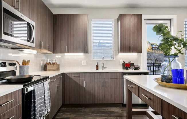 A kitchen with brown cabinets and a white counter.