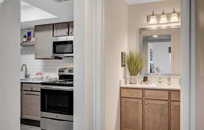A kitchen with a stove top oven and a microwave above it.