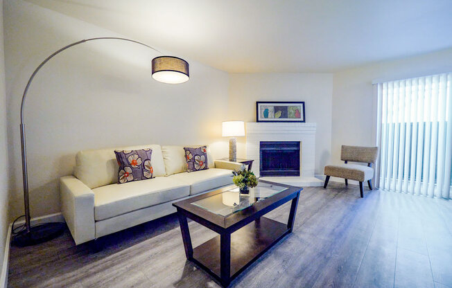 a living room with a couch coffee table and fireplace