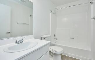 a room with a sink and a mirror