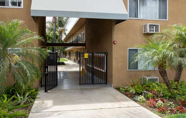 A building with a gate and a walkway leading to it.