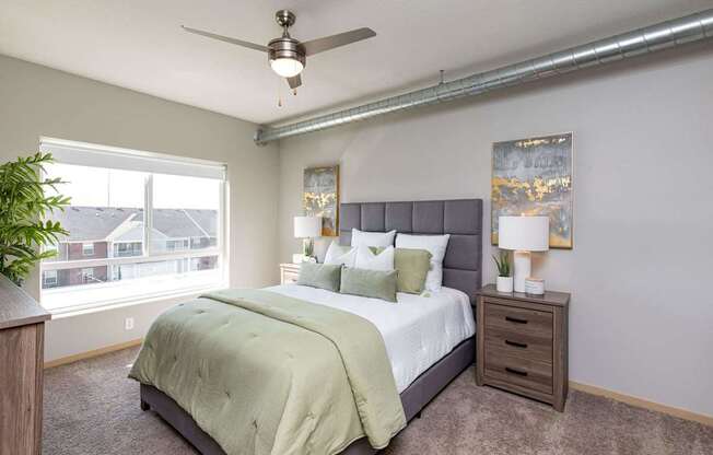 a bedroom with a large bed and a ceiling fan at Lake Shore Apartments, Iowa, 50021