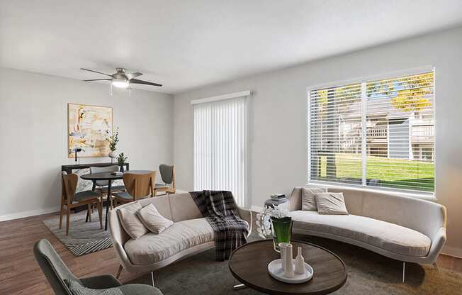 Model Living Room with Wood-Style Flooring and Patio Accessibility at Overlook Point Apartments in Salt Lake City, UT.