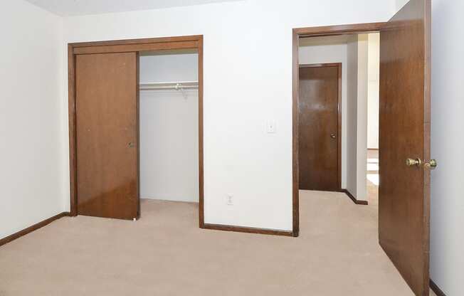 Carpeted Bedroom with Sliding Closet Doors