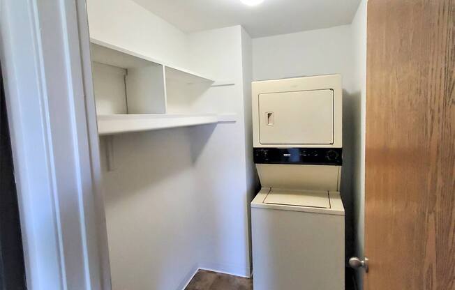 A small laundry room with a washer and dryer.