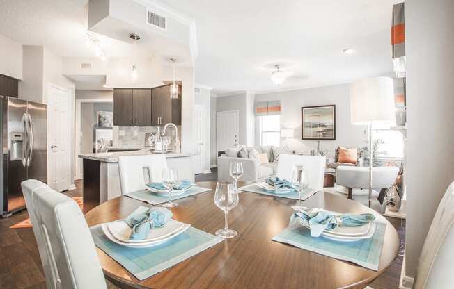 a living room and dining room with a table and chairs