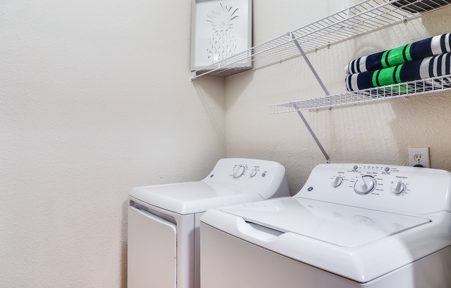 A white washing machine and dryer in a laundry room, Plantation Crossing, Lafayette, LA, 70508