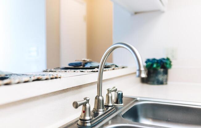 a kitchen with a sink and a mirror