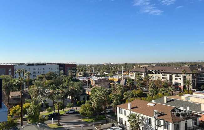 a view of the city from the balcony of a condo