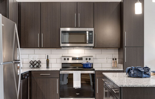 a kitchen with stainless steel appliances and wooden cabinets