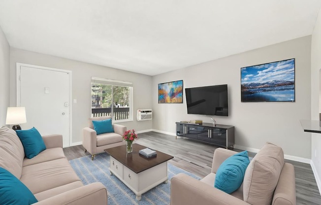 A living room with a white sofa and a coffee table.