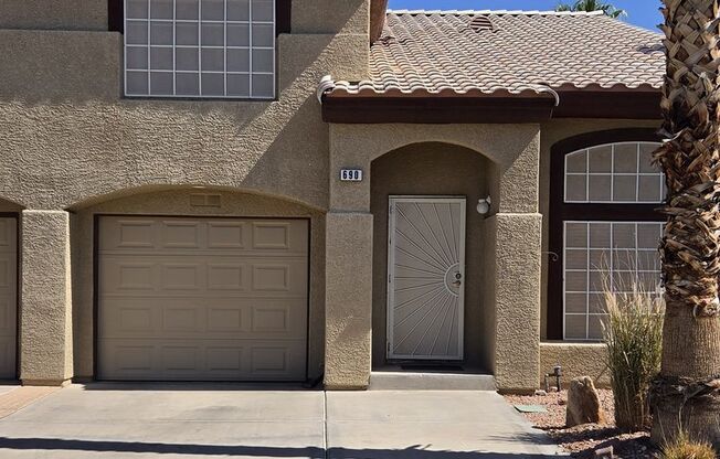 Two story 2 bedroom townhome with newer flooring, paint & appliances - community pool!