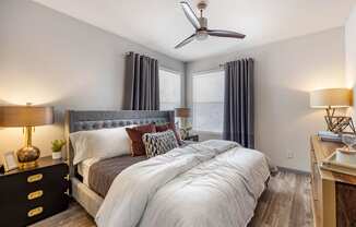 a bedroom with a large bed and a ceiling fan at Paisley and Pointe Apartments, Las Vegas, 89130